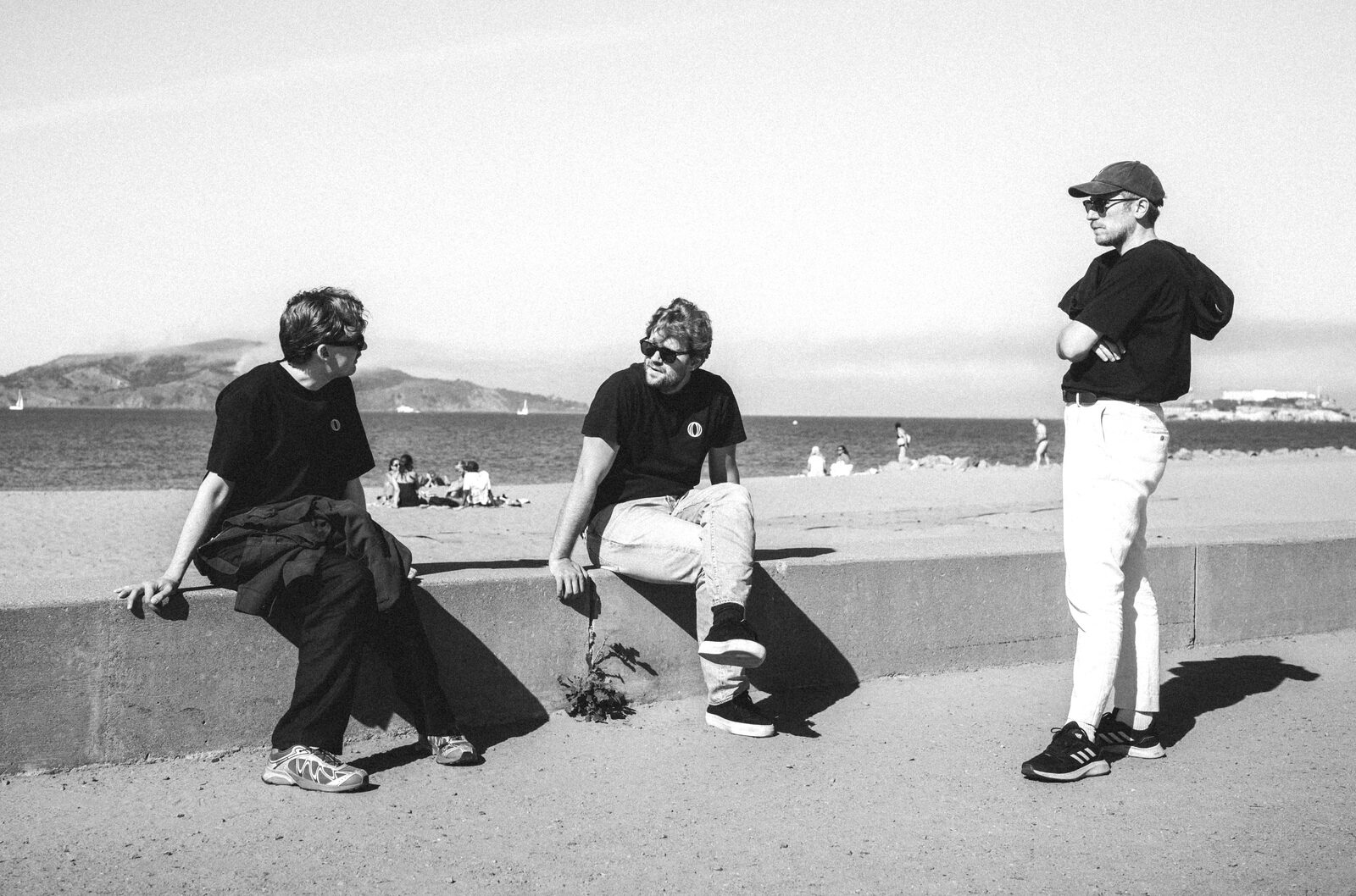 Three members of the Polar team in San Francisco, with the bay and Alcatraz behind them